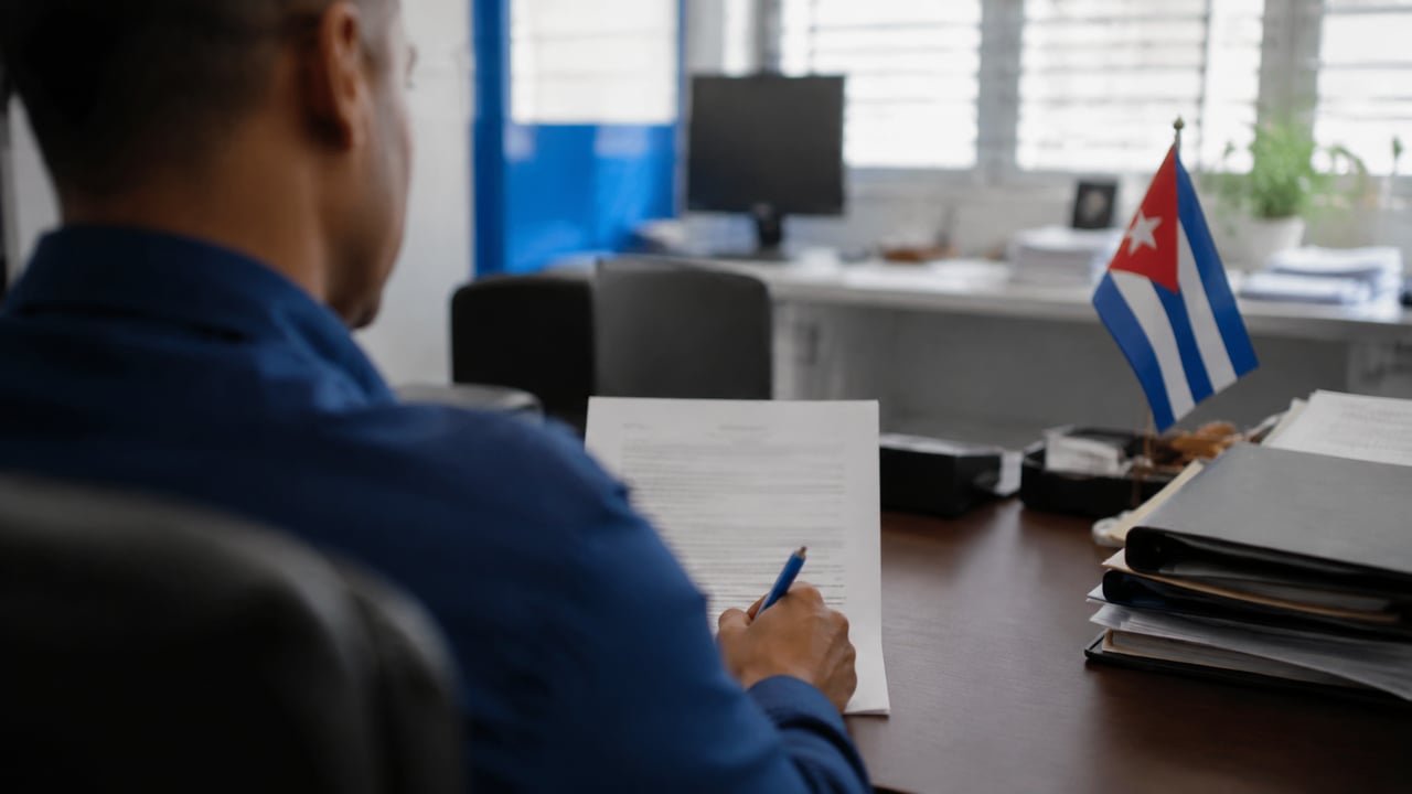 Trabajador cubano firma un contrato de empleo en una oficina en Cuba tras el Decreto-Ley 128 sobre contratación directa de empresas extranjeras